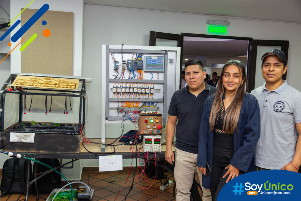 Estudiantes de Ingeniería Mecatrónica con su proyecto.